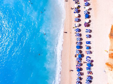 Top down view of a beach with tourists suntbeds and umbrellas wi clipart