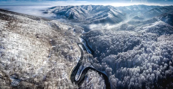 Panoramic image of a winding road from a high mountain pass in T — Stock Photo, Image