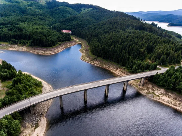 Bridge crossing lake aerial view