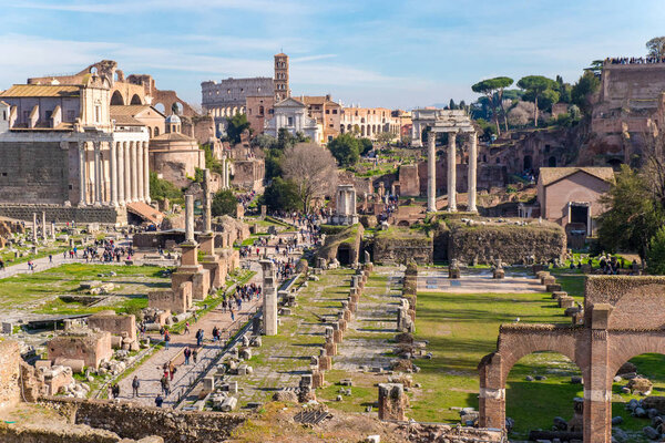 The ruins of the Roman Forum in Rome, Italy with the Colosseum v