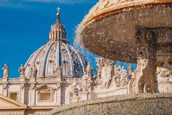 Saint Peter's Basilica  dome and the fountain in front in Vatica