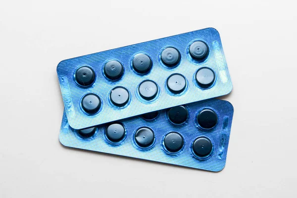 Black pills on white background — Stock Photo, Image