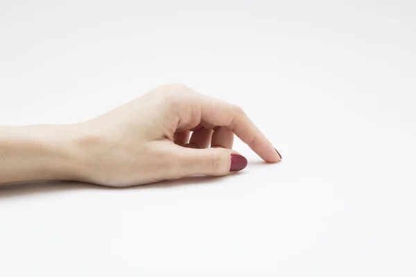 Руки з червоним манікюром на білому тлі Стокове Фото