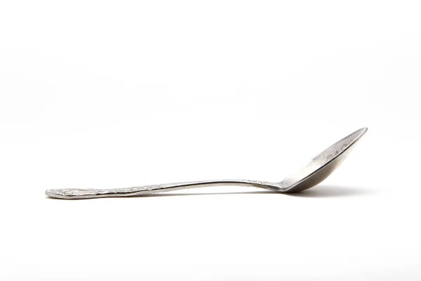 Metal spoon on a white background — Stock Photo, Image