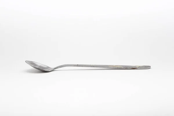 Metal spoon on a white background — Stock Photo, Image