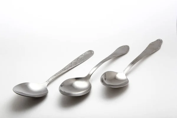 Metal spoon on a white background — Stock Photo, Image