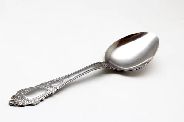 Metal spoon on a white background — Stock Photo, Image