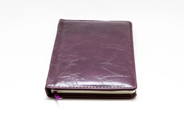 Notepad in a leather cover on a white background