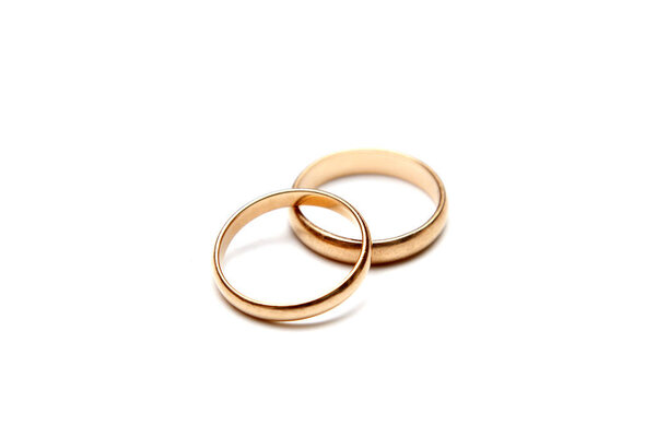 Gold wedding rings on white background