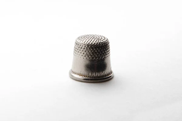 Old thimble for finger on a white background — Stock Photo, Image