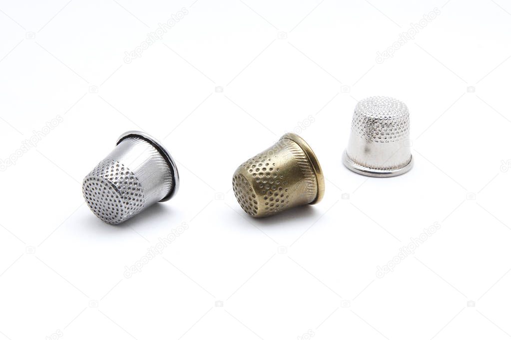 Old thimble for finger on a white background