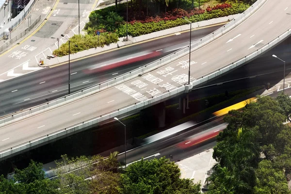 A bird eye view of an elevated highway and cars in motion in the city of Hong Kong, China