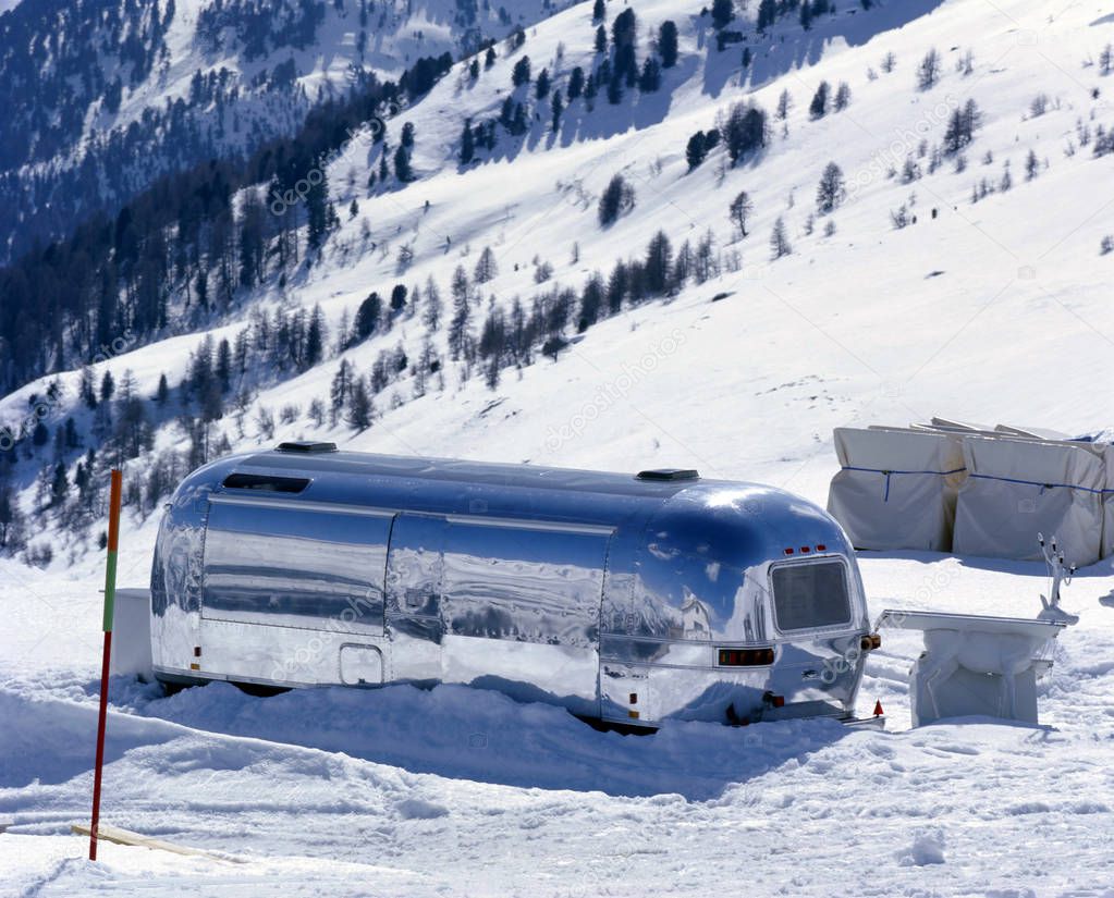 A cafe caravan in the snow covered landscape in the alps switzerland