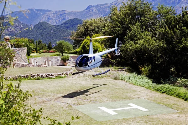 A flying helicopter bring tourists to a beautiful luxury hotel in Ravello, Italy
