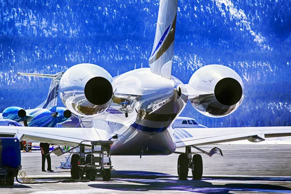 Putting fuel to a private jet in the airport of St Moritz Switzerland in the alps