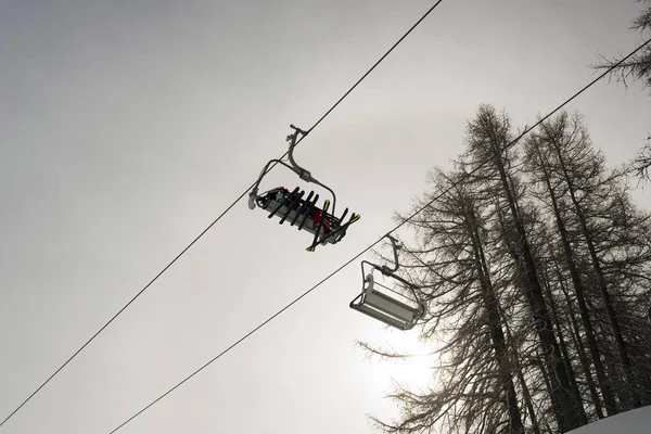 A ski lift and a cable car in the alps switzerland in winter