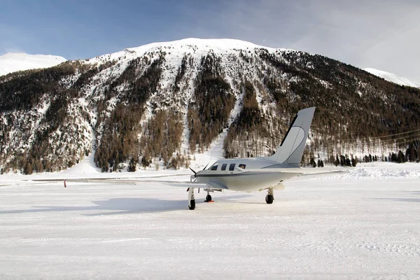 A private jet in the snow covered airport of St Moritz in the alps switzerland in winter