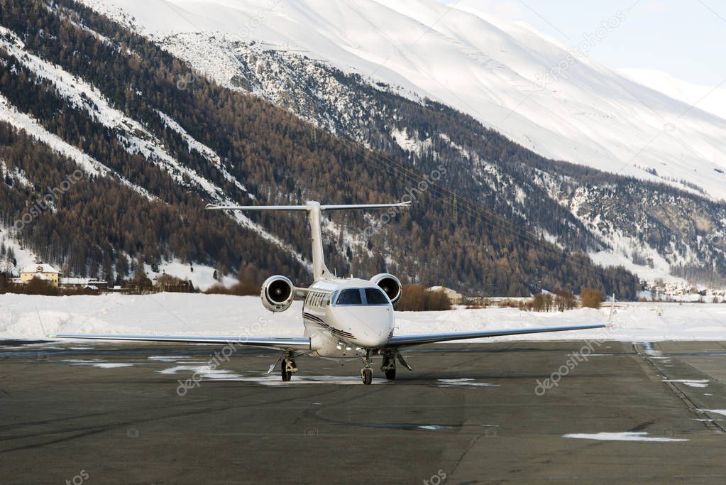 A private jet is ready to take off in the airport of St Moritz Switzerland in winter