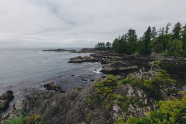 Adalar, uçurumlar ve bulutlar ile uzak kıyı görünümü