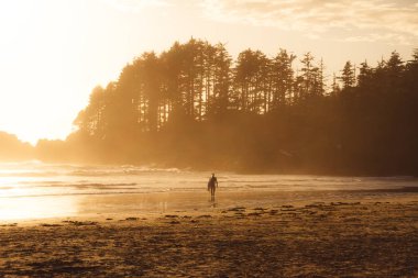 Sörf üzerinde yürüyen adam orman ile plaj 