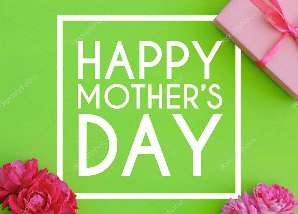 happy mothers day text with frame and pink roses, gift box on green background.