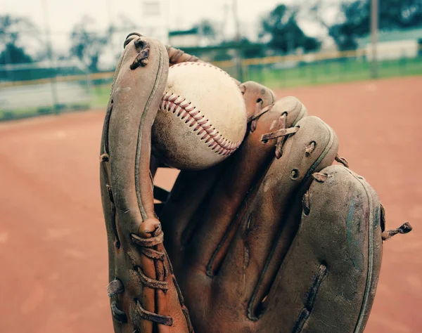 Baseball player with old glove and ball for game of catch