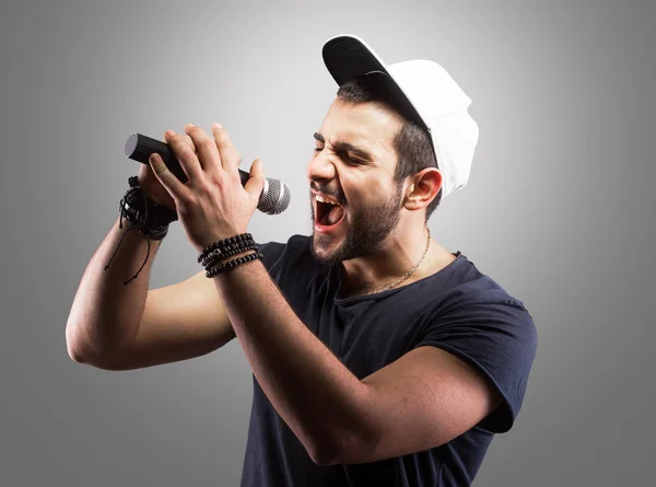 Young man singing into a microphone