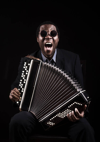 Funny portrait of the african black man with ethnic musical inst