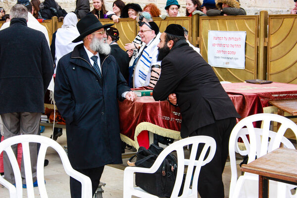 Unknowns people praying front the Western wall at the old city of Jerusalem morning