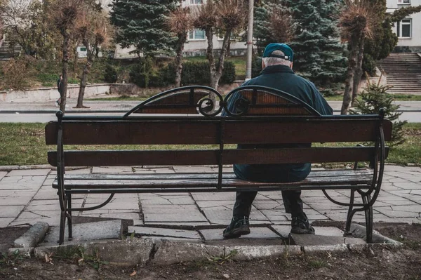 An old man sitting on a park bench