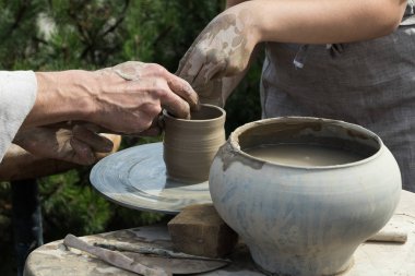 Eller iki kişinin pot, potter's tekerlek oluşturmak.