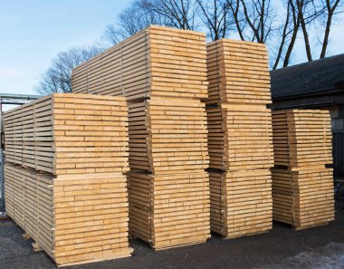 Stacks of air drying timber planks to reduce moisture clipart