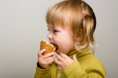 Child eating bread clipart
