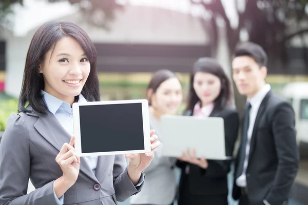 Business people show tablet — Stock Photo, Image
