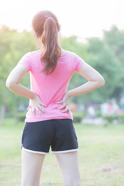 Woman waist injury in park — Stock Photo, Image