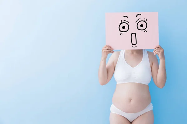 Надмірна вага жінки з здивованим рекламним щитом — стокове фото