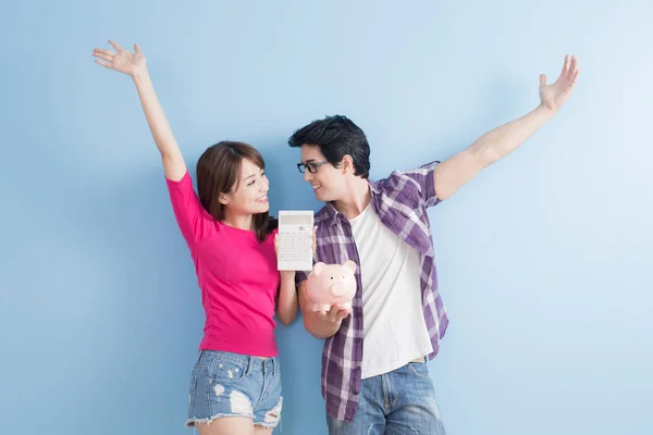 Couple holding  pink pig bank and calculator — Stock Photo, Image