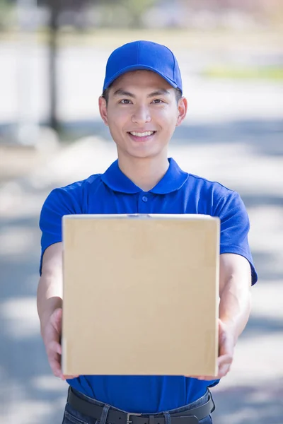 Deliveryman standing  and smiling — Stock Photo, Image