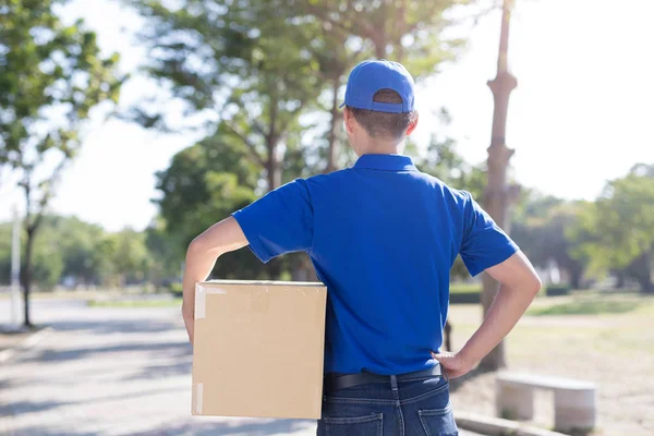 Young deliveryman standing — Stock Photo, Image