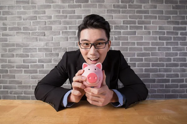 Business man holding  piggy bank — Stock Photo, Image