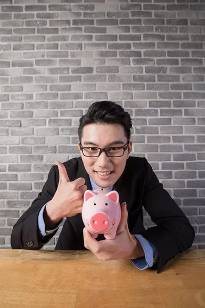 Business man holding  piggy bank — Stock Photo, Image