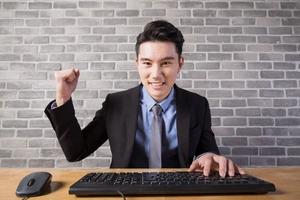 Man sitting and showing fist — Stock Photo, Image