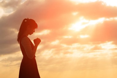 woman praying  pious with sunrise clipart