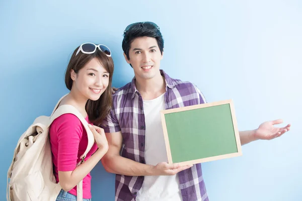 Couple showing  blank green chalkboard — Stock Photo, Image