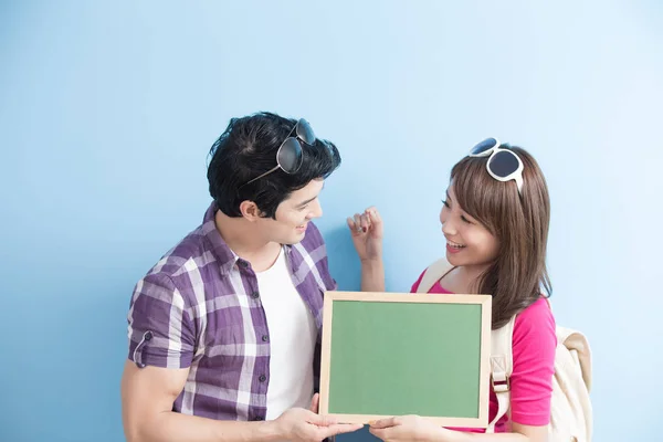 Couple showing  blank green chalkboard — Stock Photo, Image