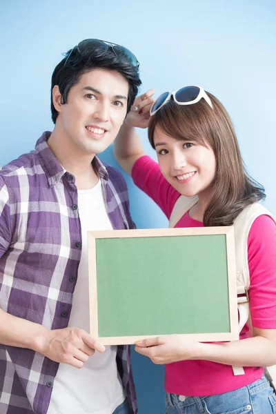 Couple showing  blank green chalkboard — Stock Photo, Image