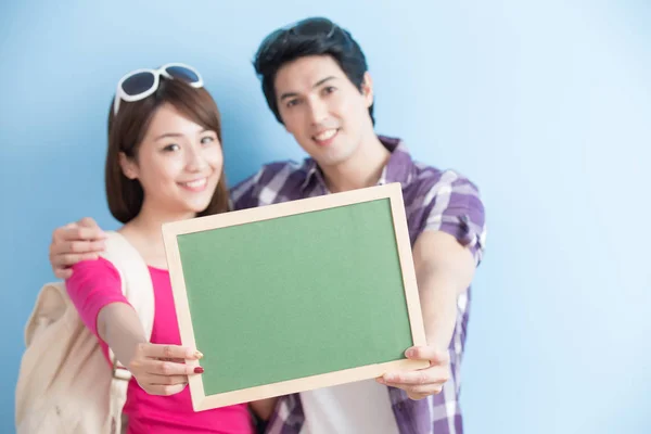 Couple showing  blank green chalkboard Stock Picture