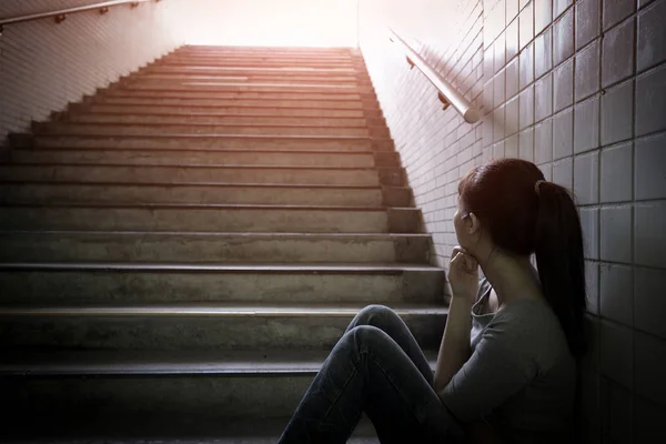 Depressed woman in underground — Stock Photo, Image