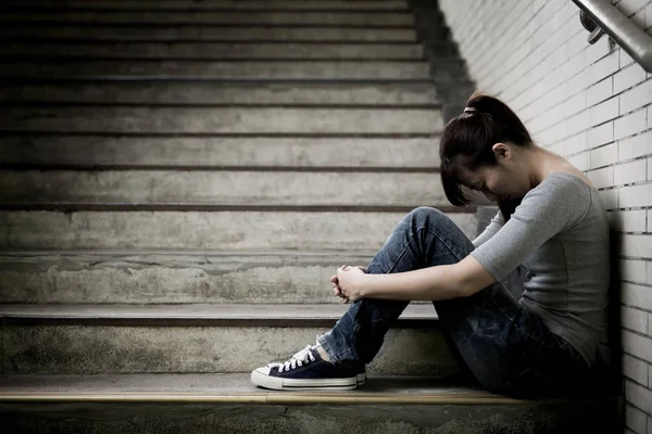 Depressed woman sitting  in underground — Stock Photo, Image