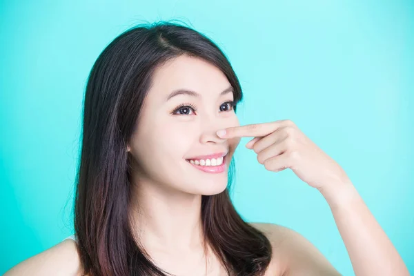 Woman smiling  and pointing her nose o — Stock Photo, Image